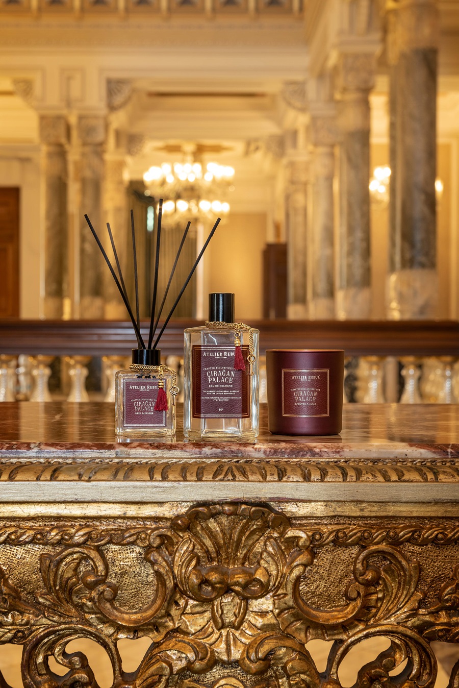 Luxury perfume and diffuser on an ornate marble bar, with amber lighting and marble pillars in the background