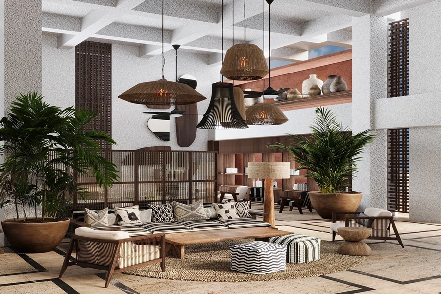 Modern hotel lobby lounge with wooden coffee table, wicker seating, and striped cushions surrounded by large potted palms and woven pendant lights.