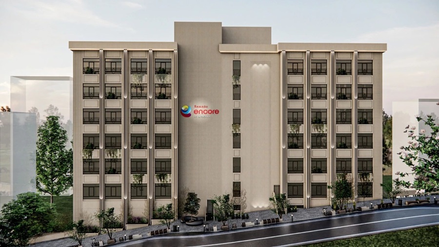 Rendering of a beige, four-story hotel/apartment building with a central vertical block and balconies on each wing, Ramada Encore logo visible on the facade.